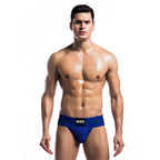 String homme bleu porte sur le corps, modele torse nu de face : ceinture MOB marquee, pochette avant galbante et maille extensible pour un sous-vetement osе.