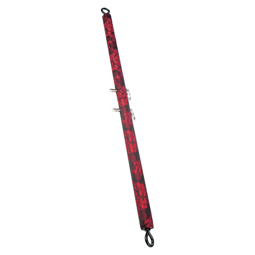 Barre d'ecartement reglable Scandal habillee de brocart rouge et noir avec anneaux universels aux extremites, presentee verticale sur fond blanc, extensible jusqu'a 91 cm.
