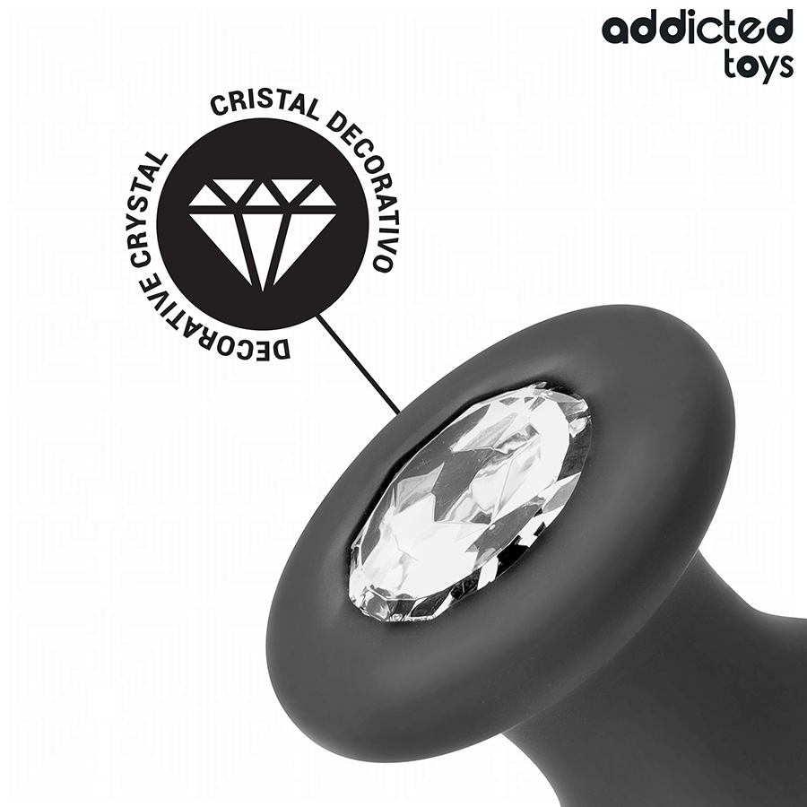 Gros plan de la base du plug anal bijou Addicted avec son cristal decoratif scintillant et picto dedie, silicone noir lisse pour une finition soignee et hygienique.