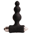 Plug anal noir à billes progressives empilées sur une base vibrante en T à embout métallisé, présenté seul sur fond clair, silicone lisse non figuratif.