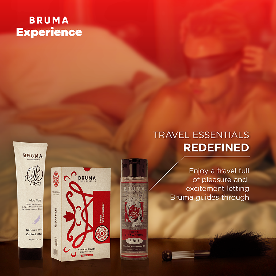Tube et flacons du kit fraise Bruma a gel vibrant en mise en scene voyage sur fond rouge chaleureux, lubrifiant et huile de massage, essentiels nomades coquins