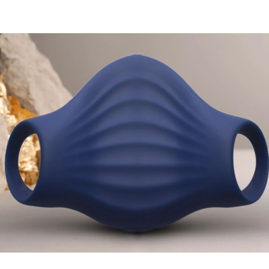 Masturbateur Palm bleu marine dressé devant une pierre claire, gaine en silicone nervuré aux boucles ouvertes, accessoire vibrant flexible 10 modes étanche.