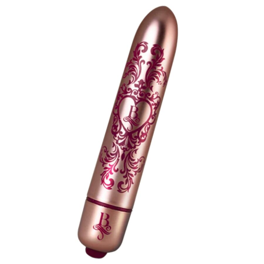 Bullet vibrant rose doré gravé d'arabesques bordeaux présenté incliné, embout coloré visible, mini vibromasseur clitoridien fin à finition baroque métallisée Rocks-Off.