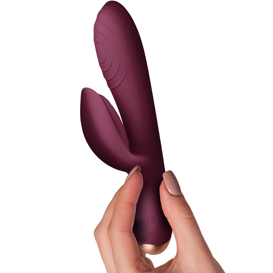 Vibromasseur rabbit Spirit tenu en main, gros plan sur les deux branches prune et la flexibilite de la tige point G, deux moteurs independants a 10 niveaux etanche.