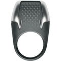 Anneau penien vibrant Tyro a LED en anthracite, vue de face sur l'anneau texture a points de contact et l'insert argente lumineux, silicone doux et ABS etanche.