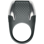 Anneau penien vibrant Tyro a LED en anthracite, vue de face sur l'anneau texture a points de contact et l'insert argente lumineux, silicone doux et ABS etanche.