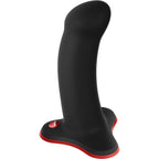 Gode réaliste noir en silicone, gland nettement modelé et tige incurvée sur base ventouse rouge, conçu pour un usage mains libres ou en harnais.