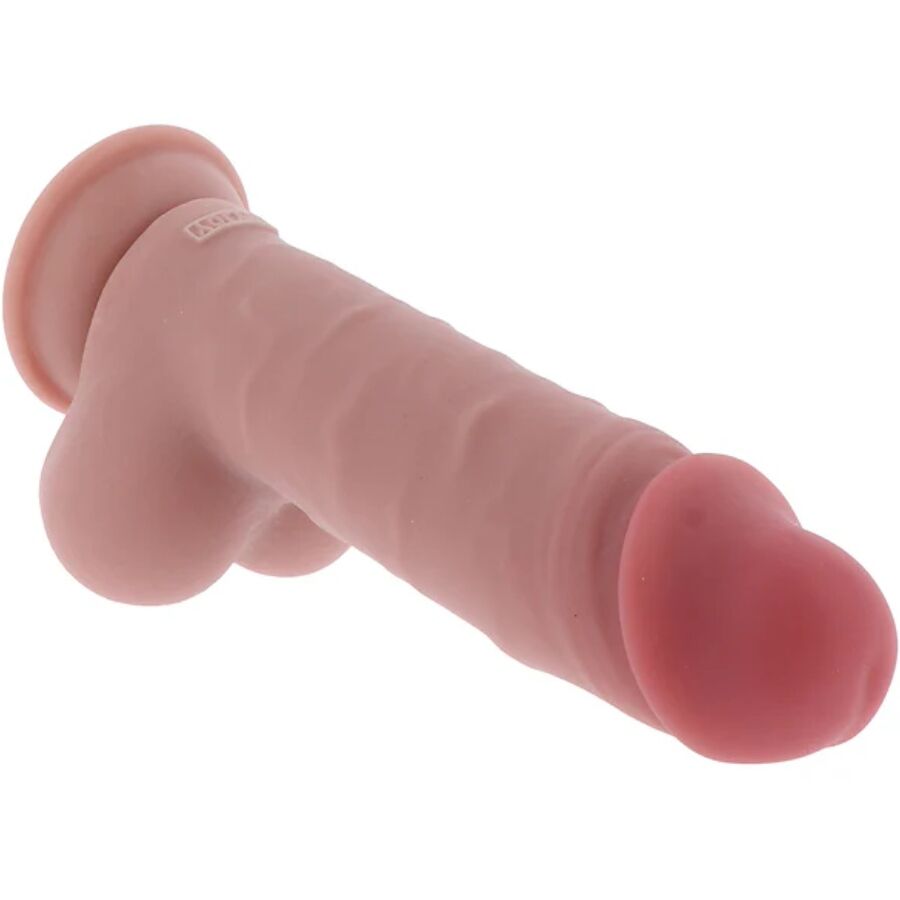Gode realiste Get Real chair avec testicules pose a plat, gland marque et ventouse visibles, silicone double densite effet peau pour un usage mains libres maitrise.