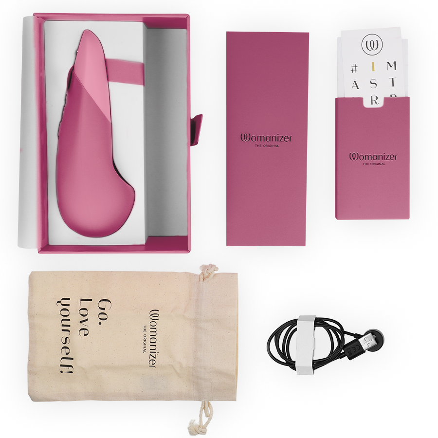 Vibromasseur à poser UltraWave Vibe rose présenté avec son écrin, câble de charge magnétique, pochette Go love yourself et cartes d'accessoires sur fond clair.