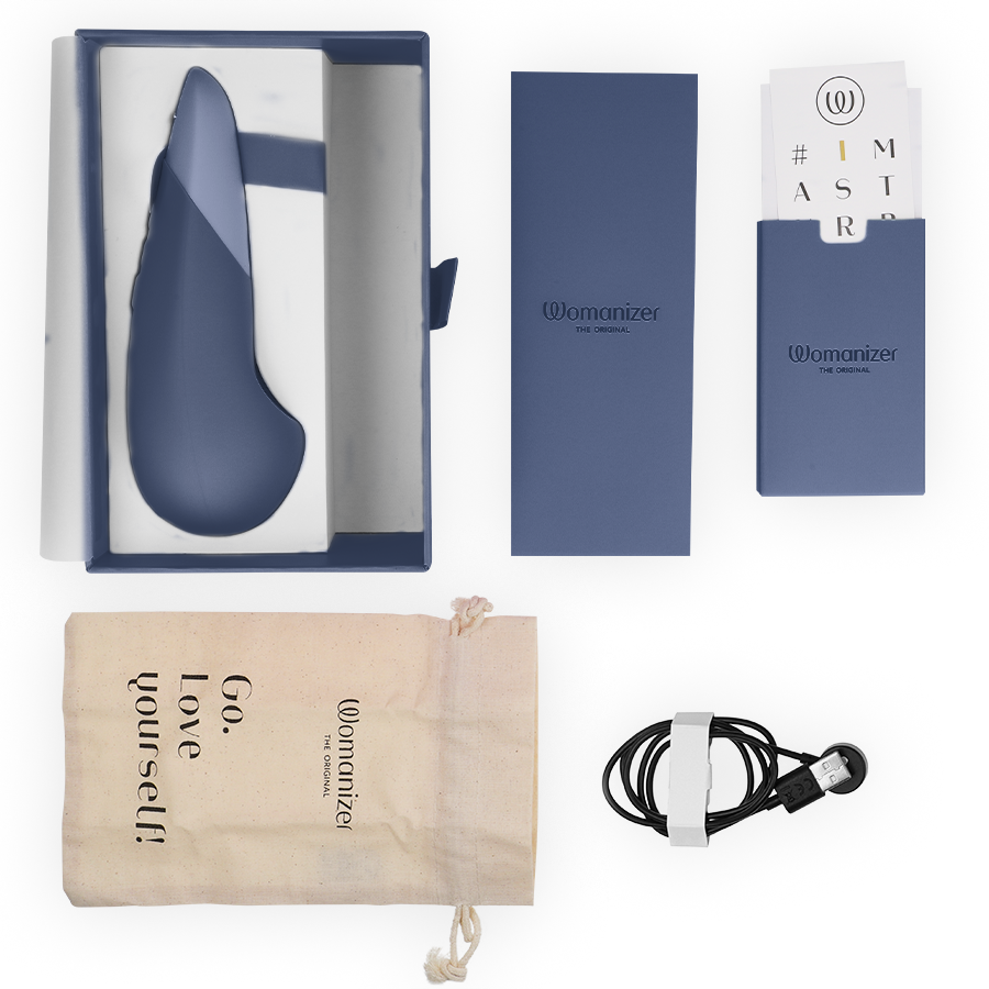Vibromasseur à poser UltraWave Vibe bleu présenté avec son écrin, câble de charge magnétique, pochette Go love yourself et cartes d'accessoires sur fond clair.