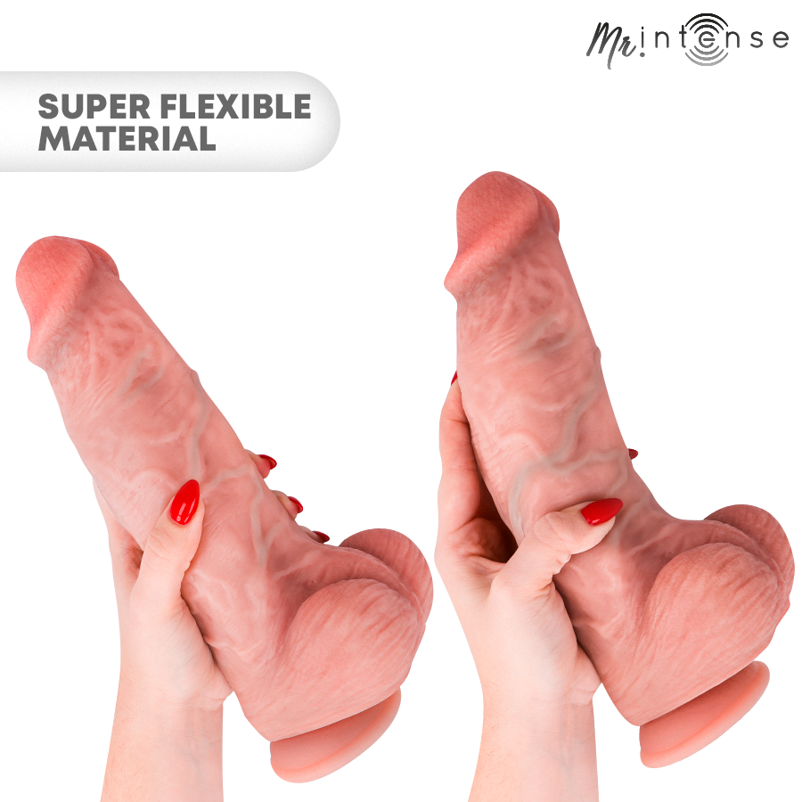 Gode realiste Intense en silicone supersoft flechi entre deux mains aux ongles rouges, mention super flexible material, ton chair veine et testicules.