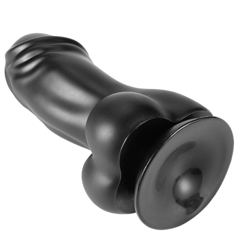 Gode XXL en PVC noir couche montrant la large ventouse circulaire et le fut courbe avec gland, angle mettant en valeur la fixation pour usage mains libres.