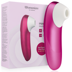 Boîte Womanizer 'Pro' rose à gauche et stimulateur clitoridien rose vif à droite : embout de succion blanc et corps galbé lisse, étoiles 'first choice', sans anatomie.