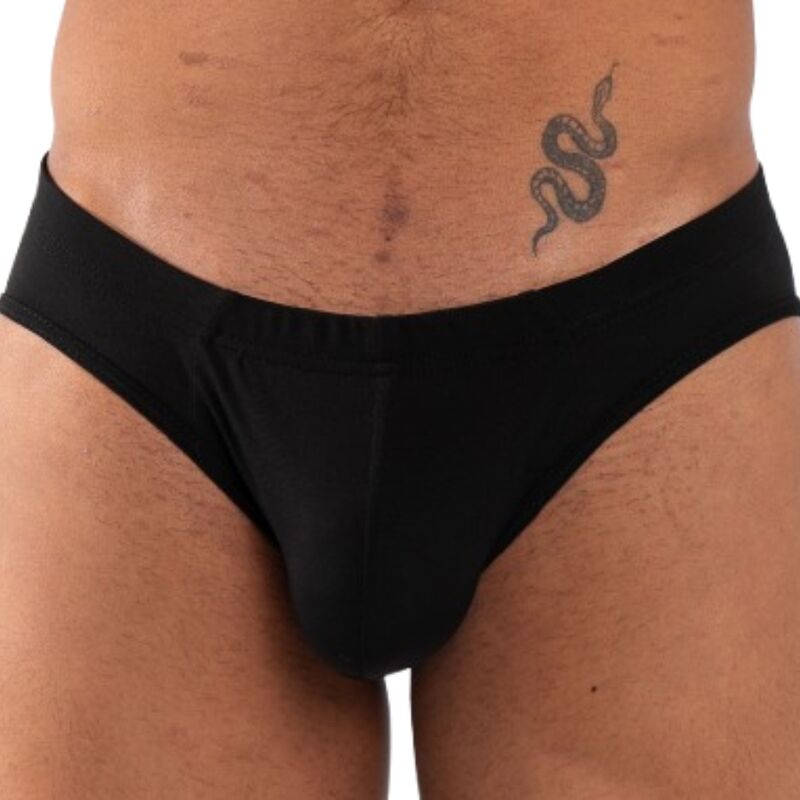 Slip noir uni vu de face en gros plan sur l'entrejambe, taille élastique noire, tatouage de serpent visible sur la hanche du modèle.