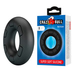 Anneau pénien Bertram noir posé à côté de son emballage Crazy Bull