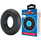 Anneau pénien Urban noir posé à côté de son emballage Crazy Bull Urban Super Soft Silicone