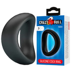 Anneau pénien incurvé Valen noir posé à côté de son emballage Crazy Bull Valen Silicone Cock Ring