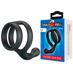 Anneau double Yancy noir posé à côté de son emballage Crazy Bull Yancy Silicone Cock Ring
