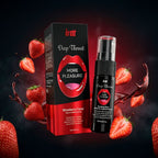 Flacon et emballage du spray Intt Deep Throat posés ensemble entourés de fraises sur fond sombre
