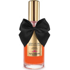 Huile de massage Light My Fire Bijoux Indiscrets, flacon orange vertical au noeud satin, formule naturelle glycerine ginseng saveur fraise miel pour caresses sensuelles.