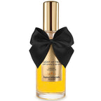 Huile de massage Light My Fire caramel sale Bijoux Indiscrets, flacon jaune vertical au noeud satin, texture fluide chauffante 100 ml pour des massages sensuels a deux.