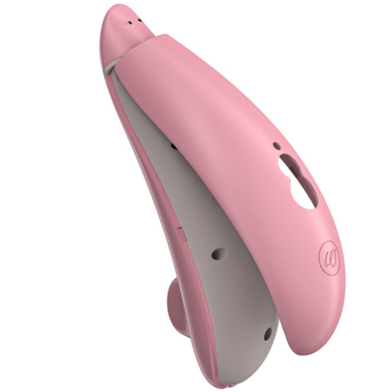 Womanizer Premium Eco rose avec sa coque entrouverte, montrant la structure intérieure grise.