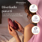Womanizer Next Liberty Bordeaux tenu en main sur un lit, avec un visuel des deux embouts en silicone.