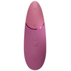 Vue arrière du Womanizer Next Rose fondu, boutons de commande et contacts de recharge visibles.