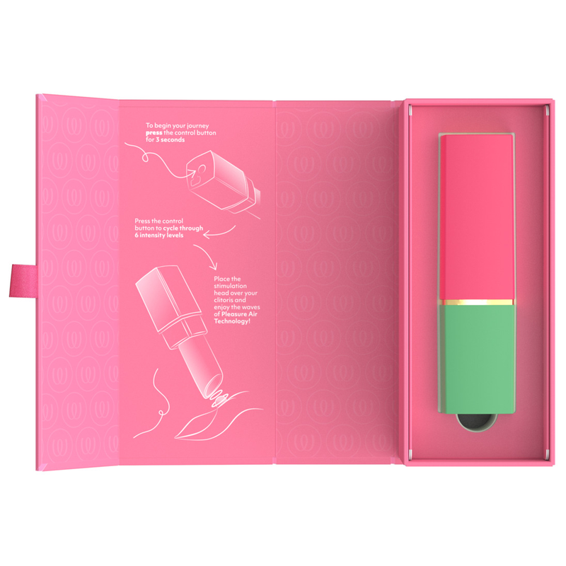 Womanizer Beauty vert et rose rangé dans son coffret rose ouvert, avec instructions illustrées.