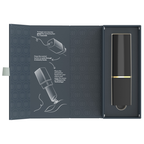 Coffret ouvert du Womanizer Beauty noir et or, avec les illustrations du mode d’emploi.