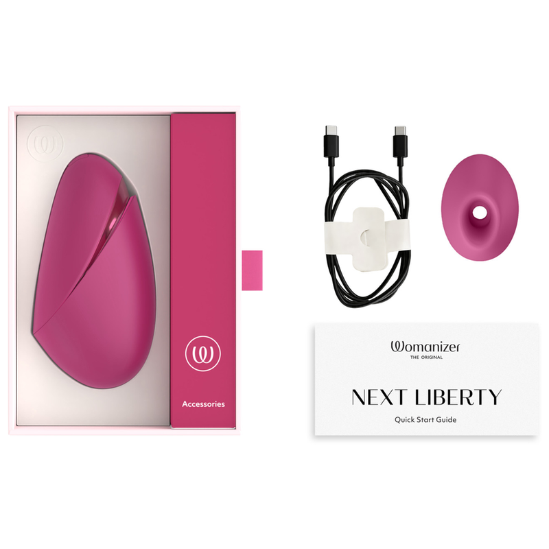 Coffret du Womanizer Next Liberty Rose avec câble USB-C, embout supplémentaire et guide de démarrage.