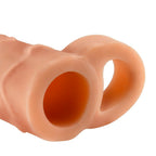 Gaine penienne Perfect 2 couleur peau de trois quarts, ouverture large et anneau testiculaire, modele souple pour rallonger et epaissir le sexe.