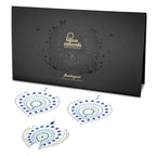 Coffret noir Flamboyant Bijoux Indiscrets avec trois elements de bijoux de corps en strass bleus et verts, parure decorative scintillante adhesive pour le corps
