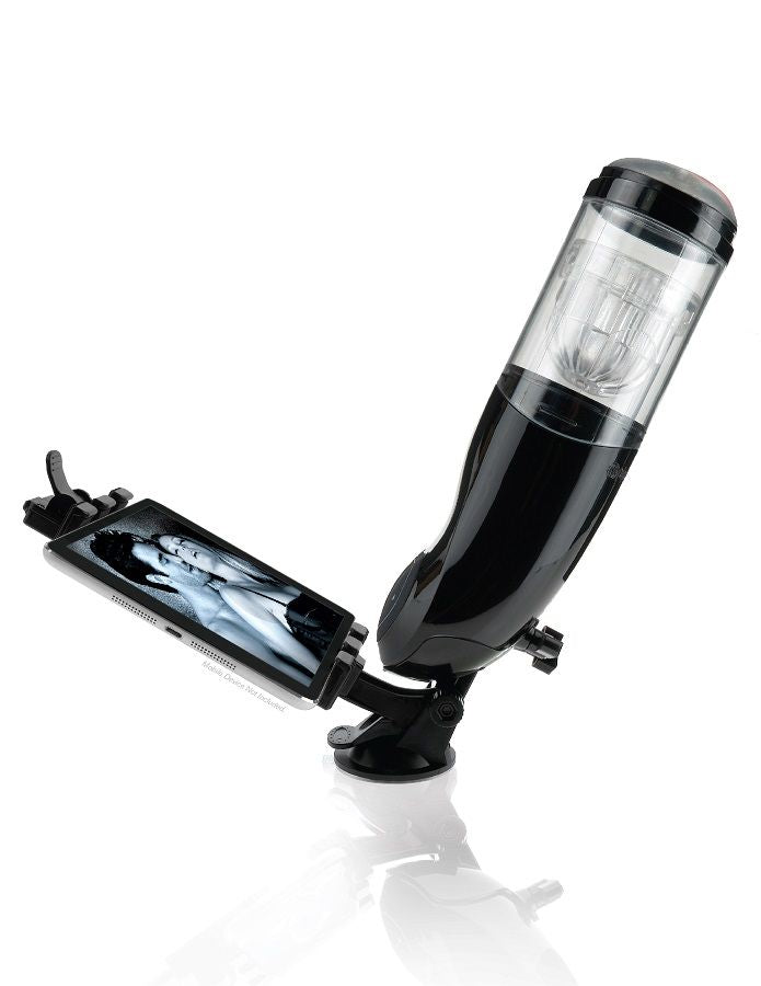 Masturbateur PDX Mega Bator noir fixé par ventouse sur une surface plane, support à pince tenant un téléphone avec image à l'écran, vue en angle avec reflet au sol.