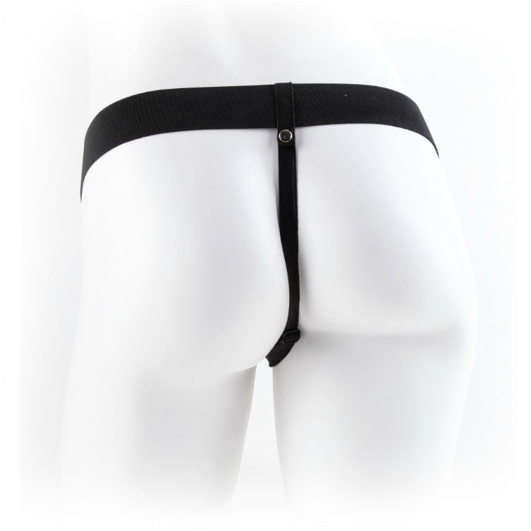 Gros plan du gode ceinture creux teinte chair sur harnais noir, ouverture du manchon et base testiculaire realiste bien visibles, modele Fetish Fantasy effet peau, sangles elastiques.