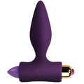 Plug anal vibrant en silicone lila à corps conique lisse sur base ergonomique en T, capsule vibrante dorée et embout violet, format compact pour débutants.