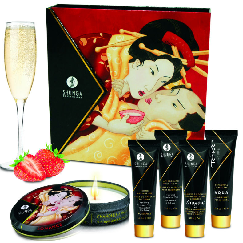 Kit Geisha Secrets Shunga fraises et cava etale avec coupe de champagne, fraise, bougie illustree d un couple et flacons, cinq produits de massage et bien etre intime