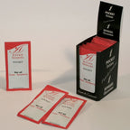 Trois sachets Extase Sensuel Pocket parfum fraise disposés devant le présentoir noir ouvert
