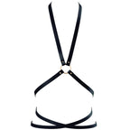 Harnais multi-voies Bijoux Indiscrets en sangles vegan noires a anneau, presente a plat, accessoire bondage chic ajustable au cou, a la poitrine et a la taille.