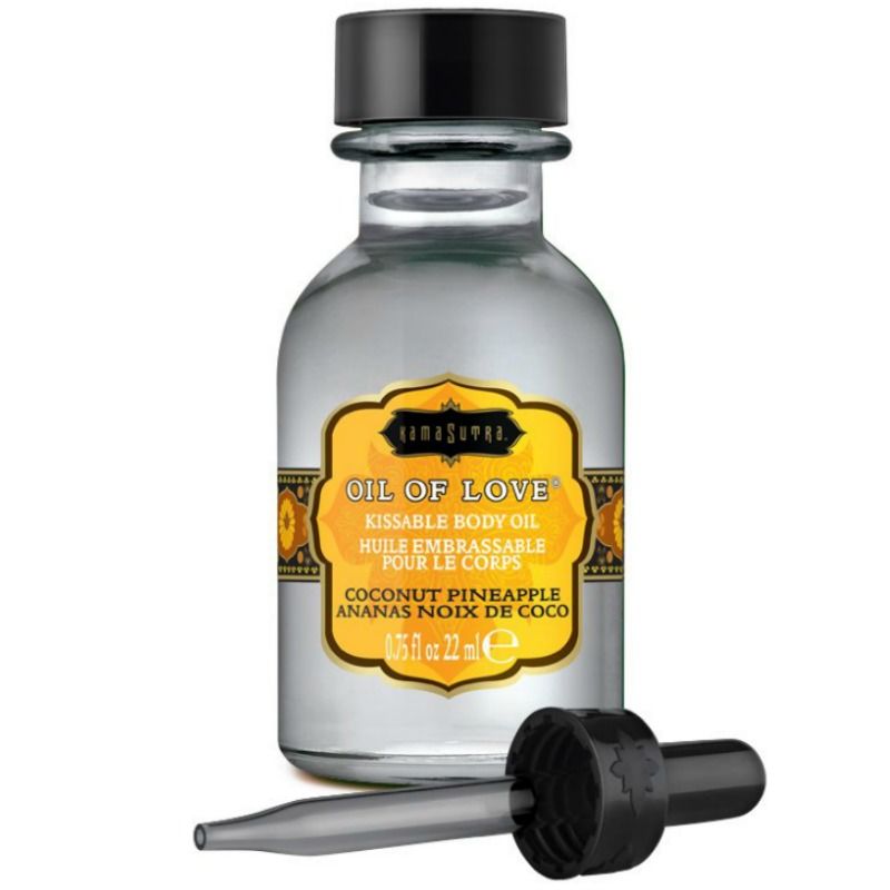 Flacon transparent Kamasutra Oil of Love coco-ananas avec pipette posee a cote, huile comestible base eau 22 ml, sensation de chaleur au souffle pour les preliminaires.