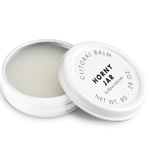 Baume clitoridien Horny Jar Bijoux Indiscrets, pot blanc ouvert laissant voir la texture cremeuse, couvercle pose a cote, cosmetique stimulant 8 g sur fond blanc