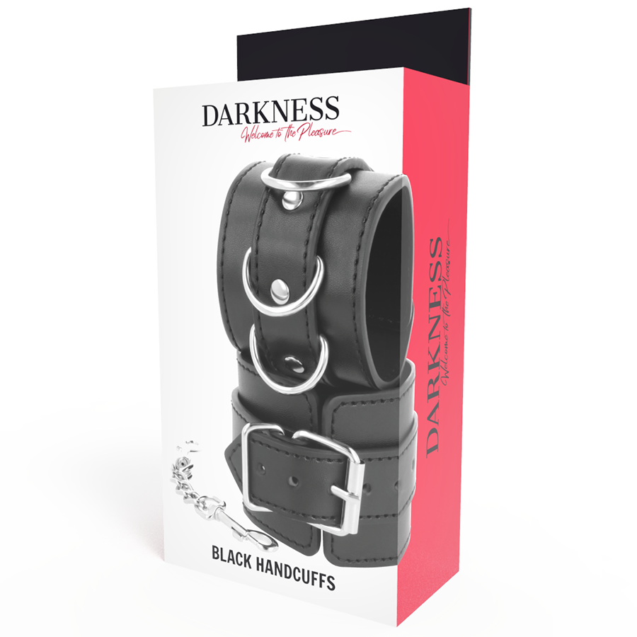 Boite Darkness Black Handcuffs presentant la menotte en cuir PVC noir a anneaux en D et chaine, packaging rouge et blanc pour le jeu de restriction BDSM.
