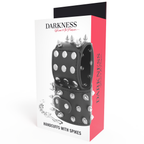 Boite Darkness Handcuffs with Spikes de face, menottes cuir noir a pointes argentees et chaine, packaging rouge et blanc pour le bondage BDSM avance.