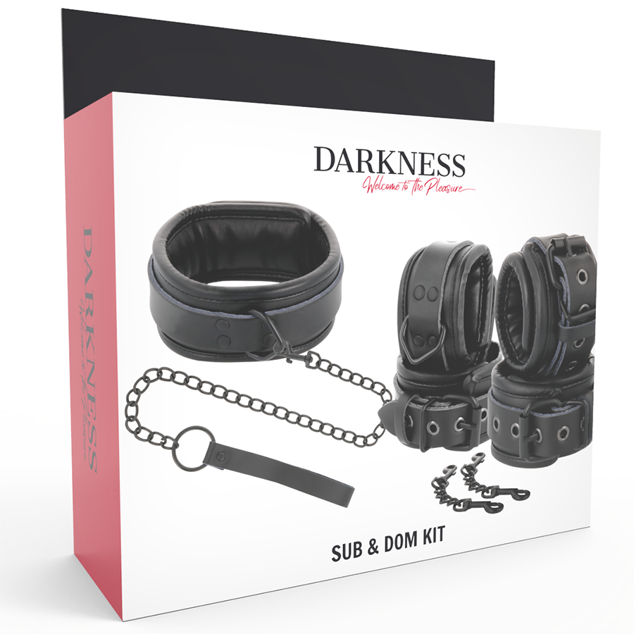 Boite Darkness Sub & Dom Kit de face, presentant le collier, les menottes en cuir noir et la laisse a chaine, packaging rouge et blanc pour le bondage.