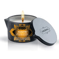 Bougie de massage Kamasutra Ignite coco-ananas allumee, couvercle metallique entrouvert pose a cote, cire fondante au beurre de karite et vitamine E pour un massage tiede.