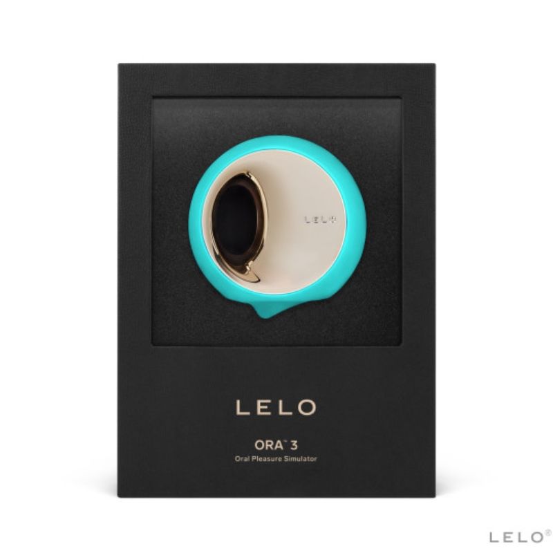 Boite Lelo Ora 3 turquoise de face, simulateur de plaisir oral sous fenetre, disque rotatif dore en silicone, mention oral pleasure simulator sur emballage noir premium.