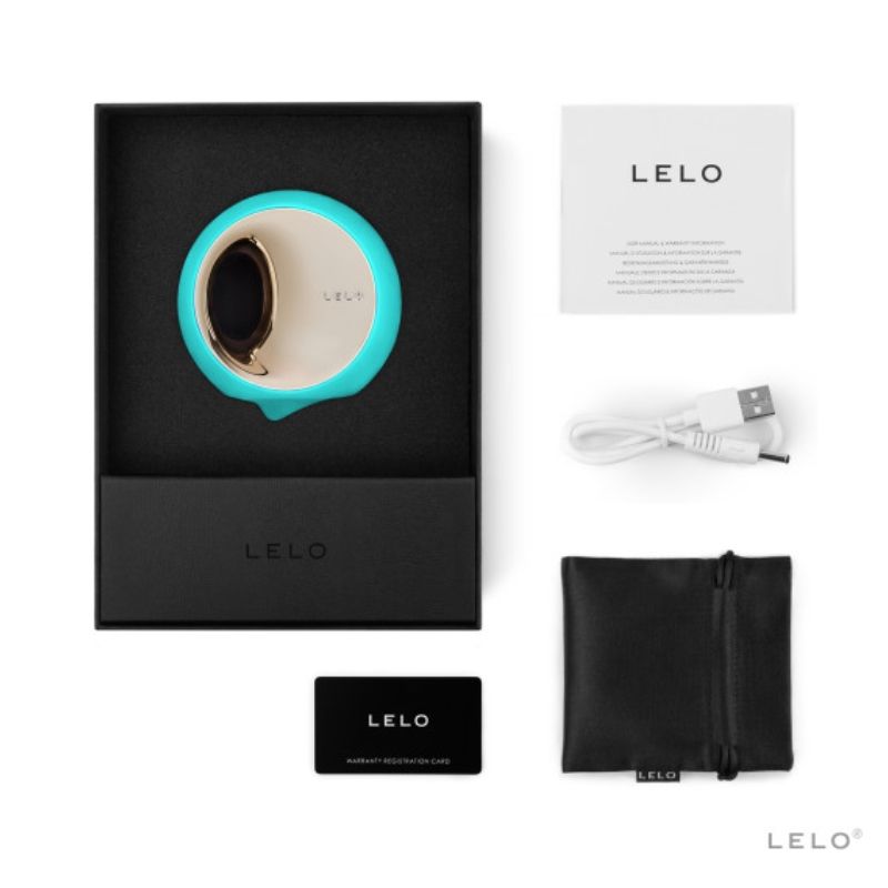 Coffret Lelo Ora 3 turquoise ouvert avec notice, cable de charge, carte de garantie et pochette noire, simulateur de plaisir oral a disque rotatif dore en silicone doux.