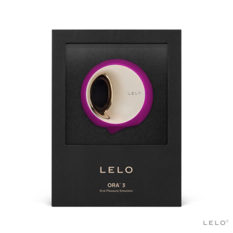 Boite Lelo Ora 3 de face, simulateur de plaisir oral fuchsia presente sous fenetre, disque rotatif dore en silicone, mention oral pleasure simulator sur l'emballage noir premium.