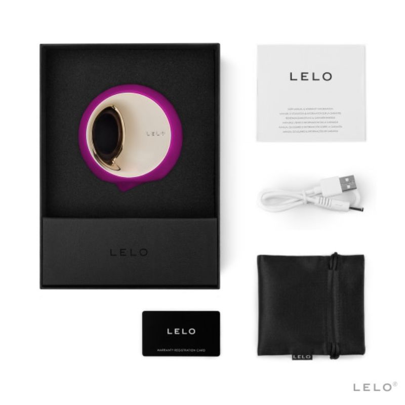 Coffret Lelo Ora 3 fuchsia ouvert avec notice, cable de charge, carte de garantie et pochette noire, simulateur de plaisir oral a disque rotatif dore en silicone doux.