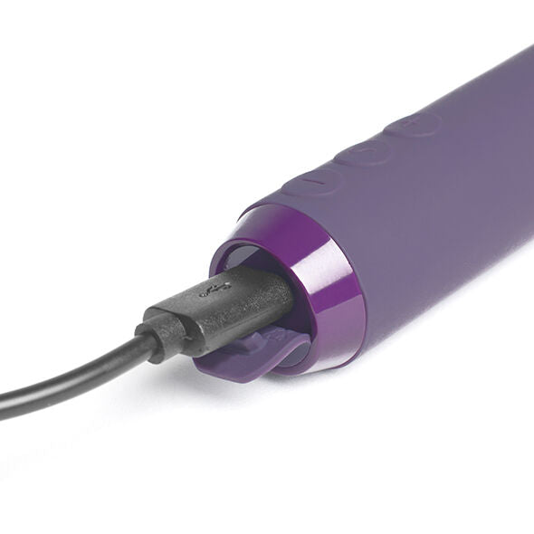 Base du mini bullet violet connectée au câble USB gris, anneau métallisé visible et corps en silicone, plan rapproché illustrant la recharge magnétique du jouet.